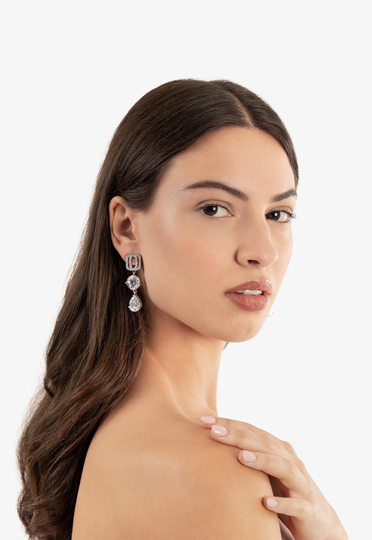 Woman wearing a delicate earring on a white background