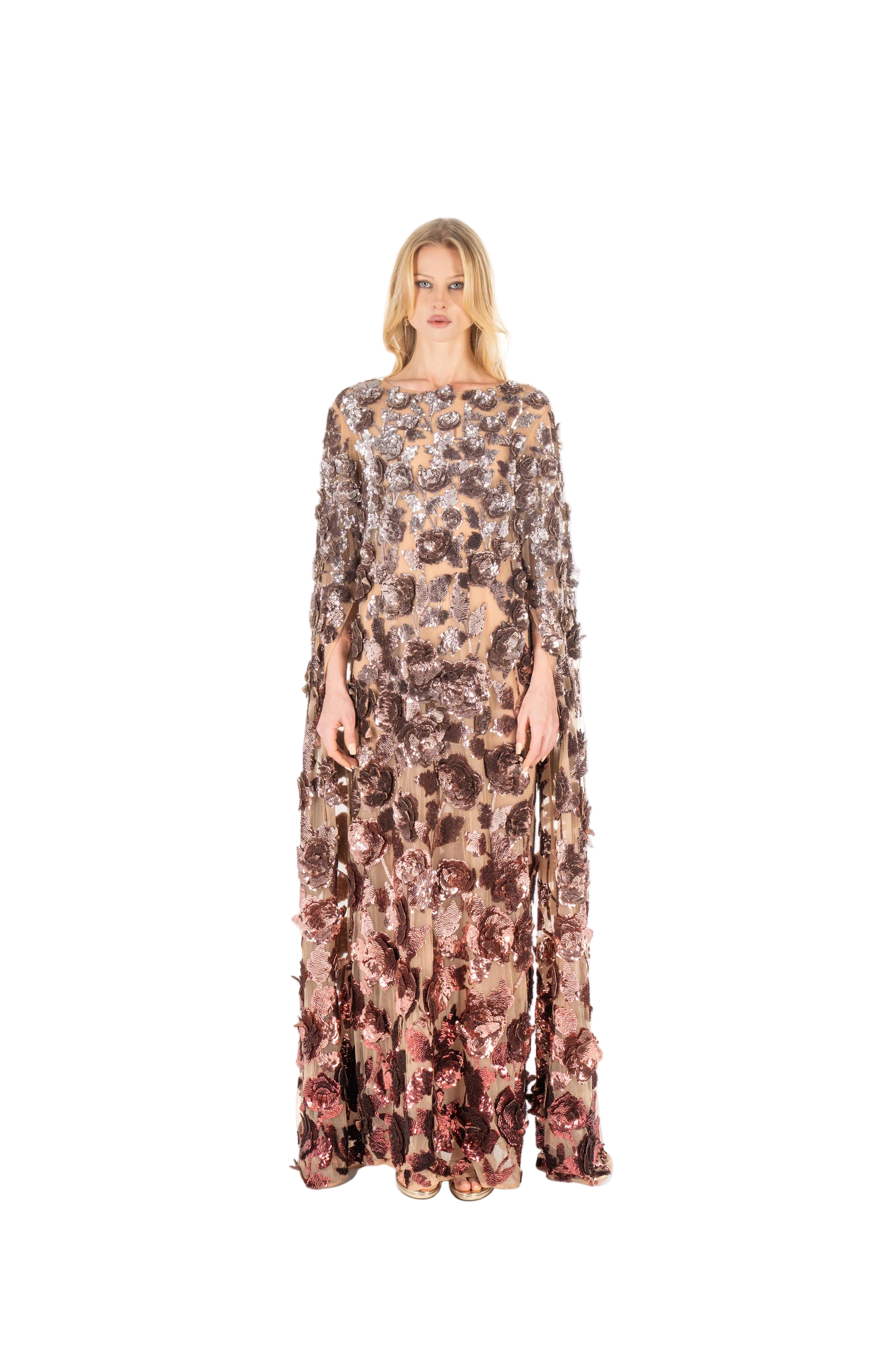 Woman wearing a long, patterned dress on a white background