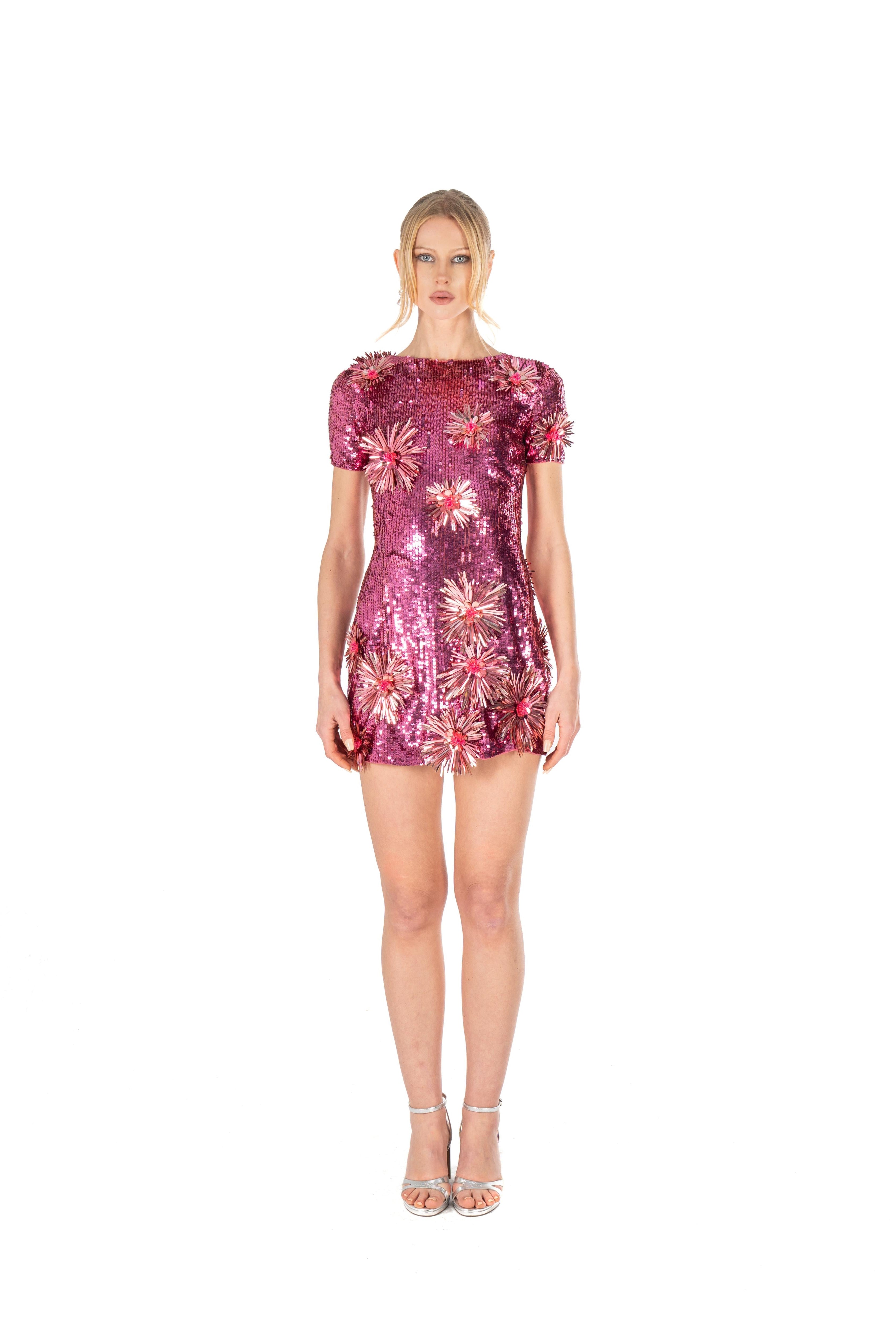 Woman wearing a pink floral dress on a white background