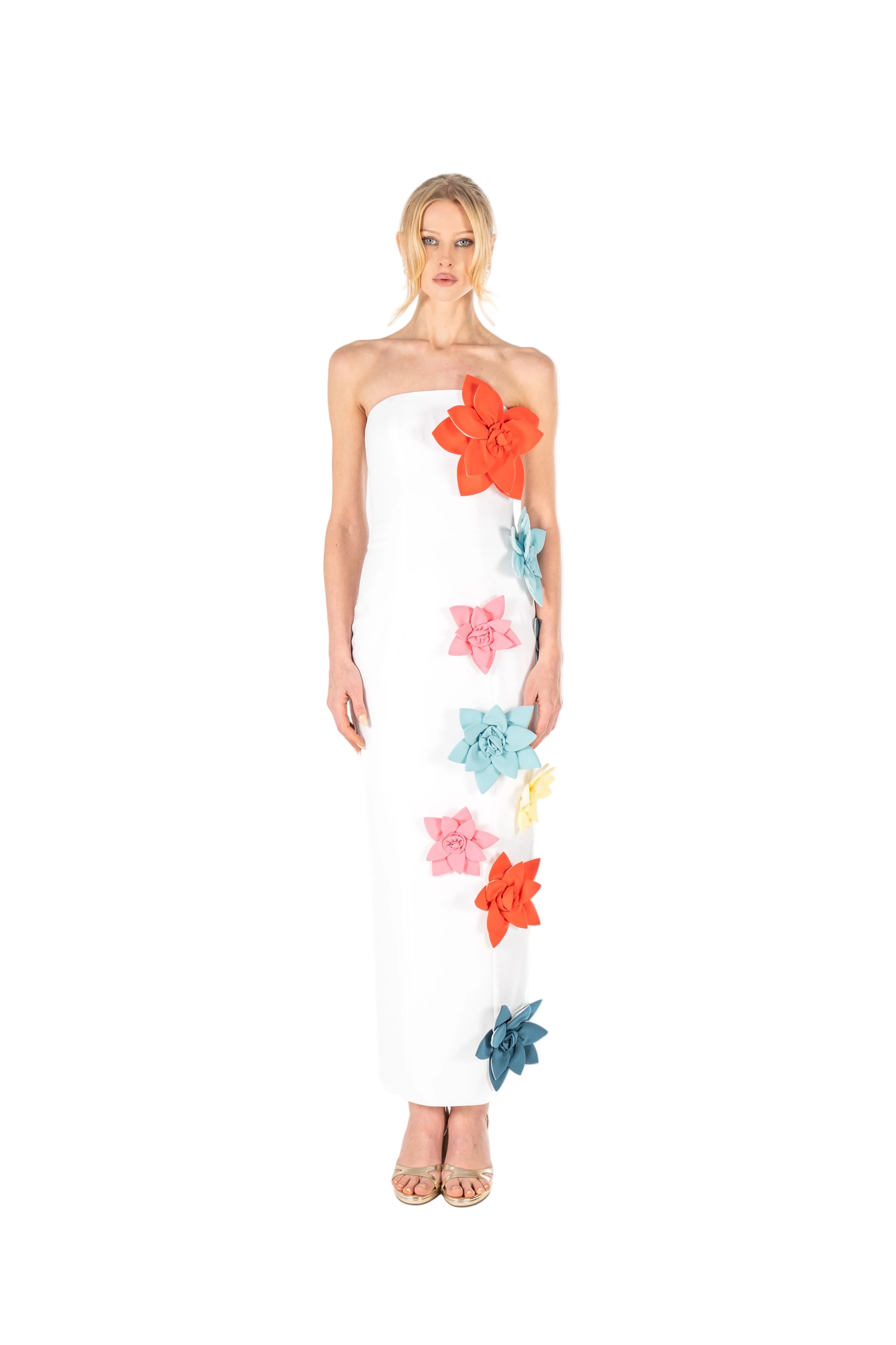 Woman wearing a strapless dress with colorful floral patterns on a white background