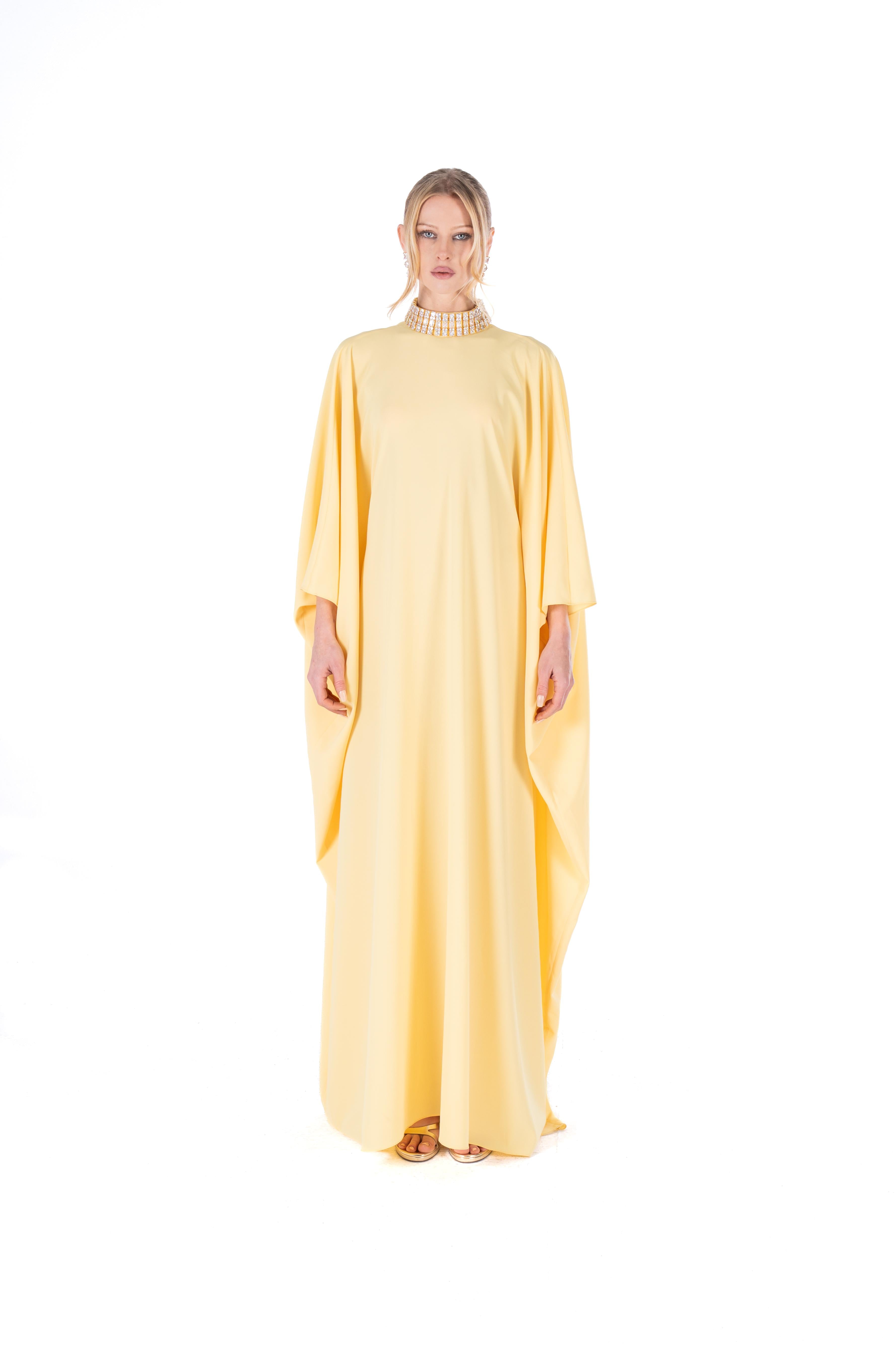 Woman wearing a yellow dress with a white background