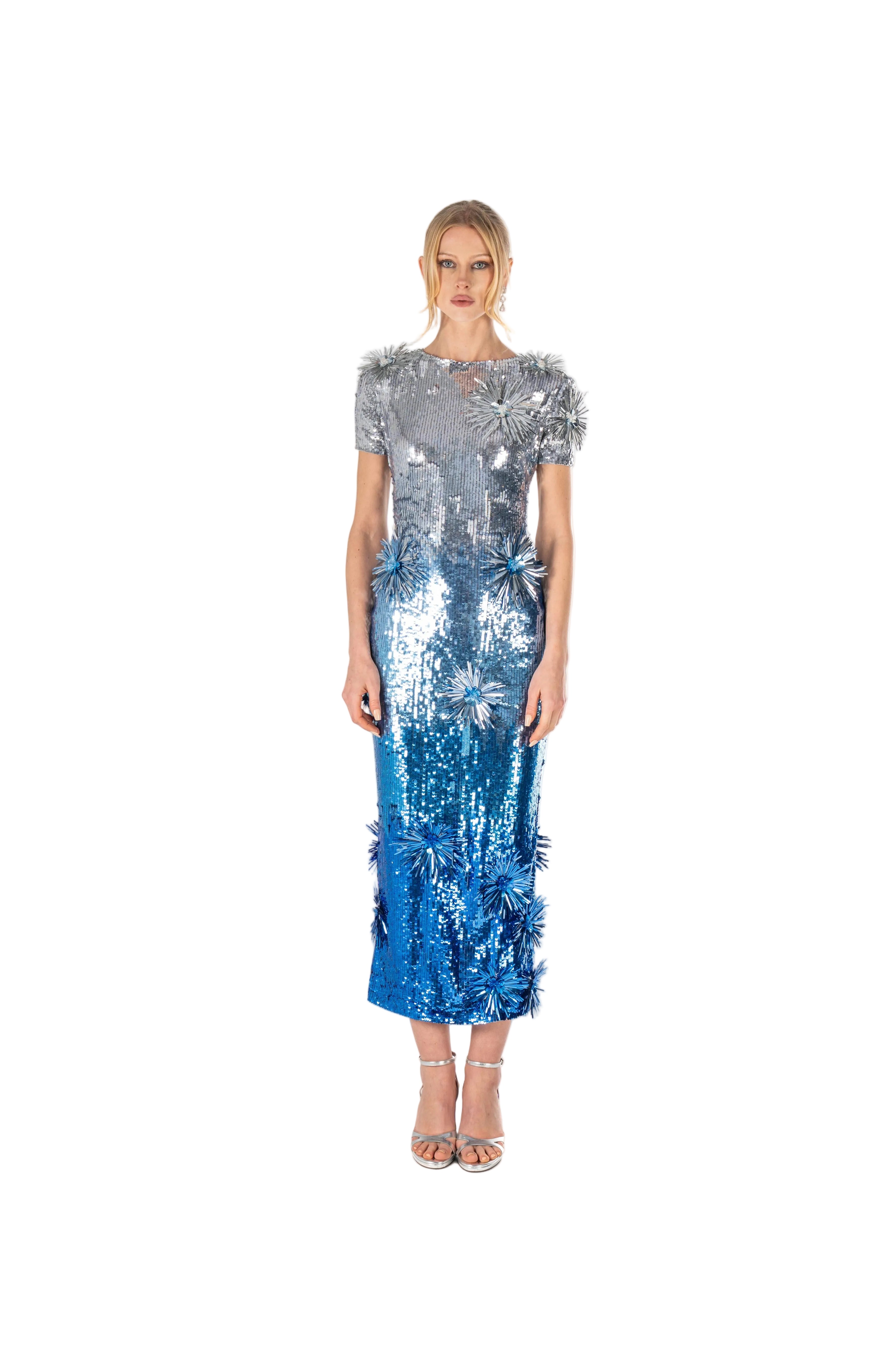 Woman wearing a silver and blue sequin dress on a white background