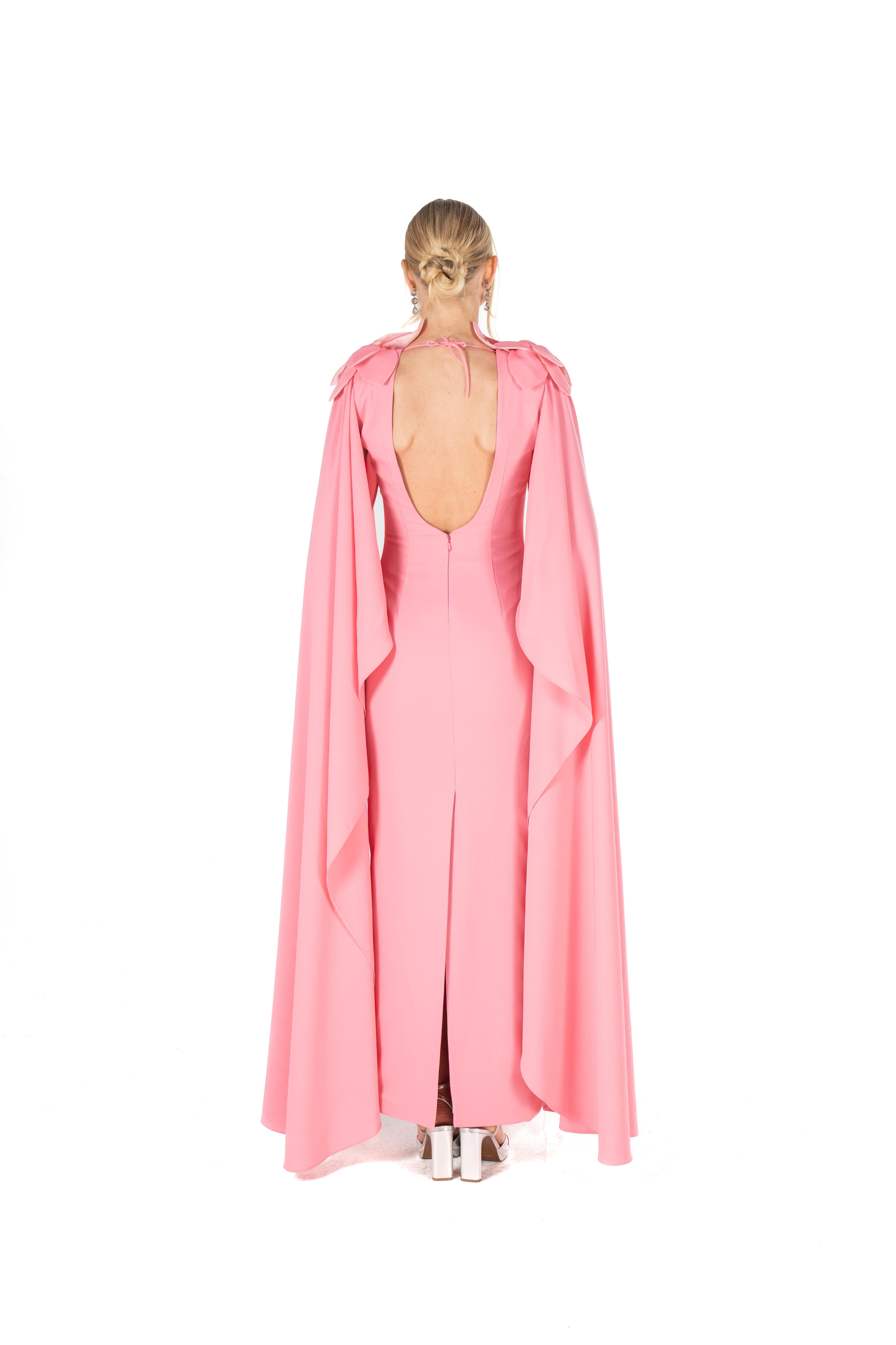 Pink cape worn by a model on a white background